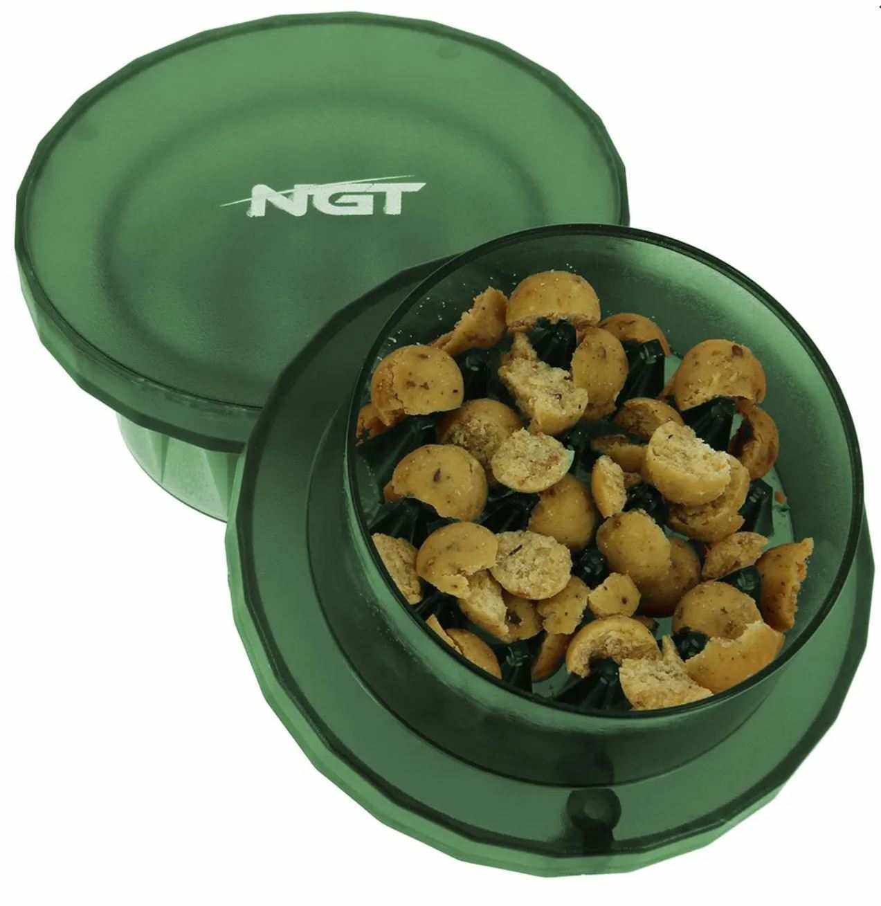 NGT Hand Held Boilie Grinder with crushed boilie pellets in green container for fishing bait preparation